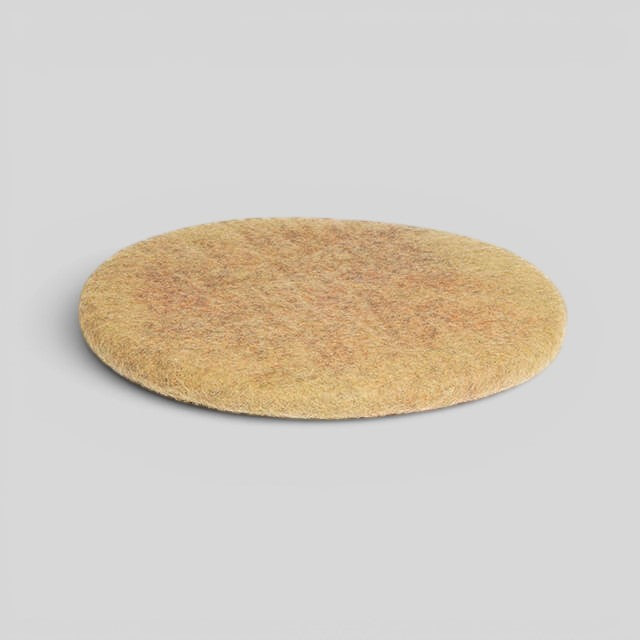 Baabuk handmade round sitting mat in natural beige wool, 40cm diameter, crafted with sustainable upcycled materials.