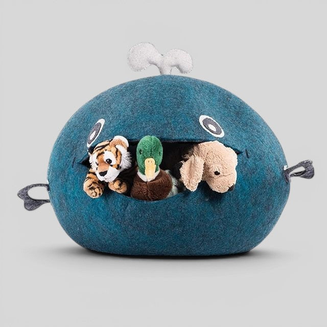 Baabuk handmade blue wool whale storage basket filled with plush animal toys, featuring hand-stitched details.