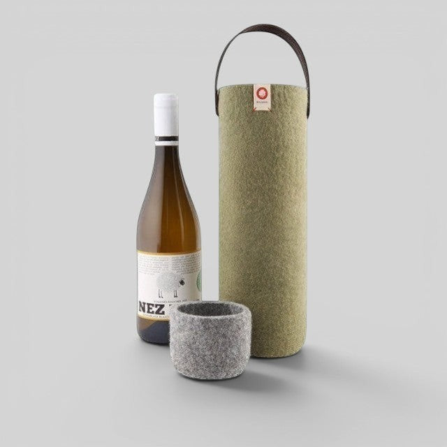 Baabuk khaki green wool wine cooler with leather handle, next to a bottle of white wine and a grey wool coaster.