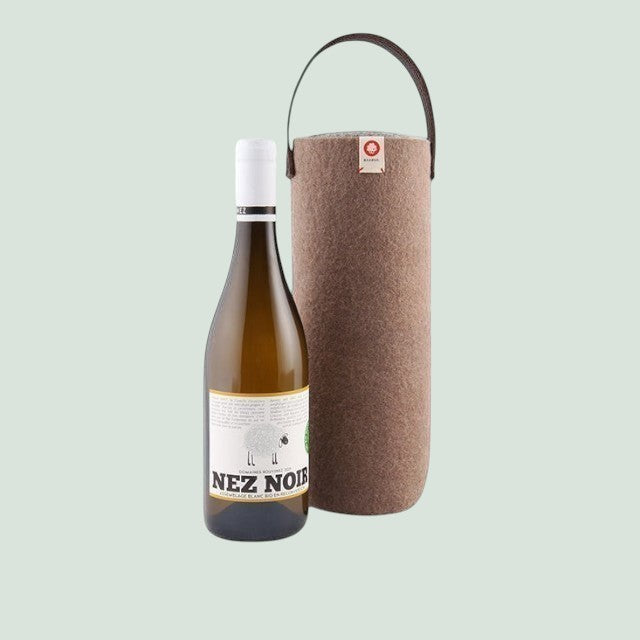 Baabuk Moka wool wine cooler with a leather strap and a bottle of white wine. Keeps wine chilled for 4 hours.