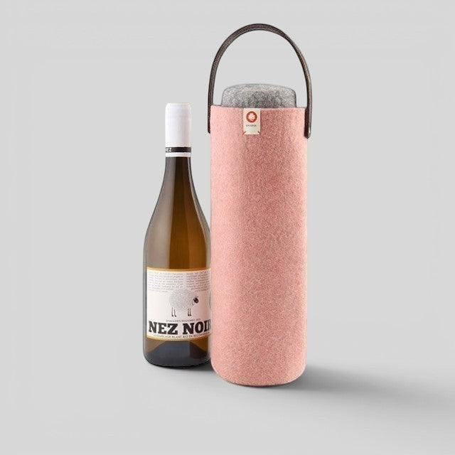 Baabuk pink wool wine cooler with a brown leather strap, keeping a wine bottle chilled for outdoor picnics.
