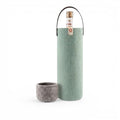Baabuk turquoise wool wine cooler with a leather strap, designed to keep wine chilled for up to 4 hours.