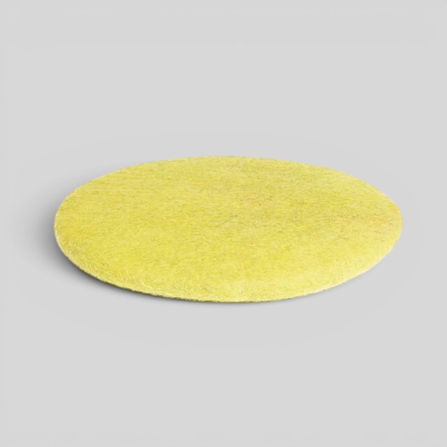 Baabuk handmade yellow round sitting mat made from natural New Zealand wool with upcycled wool stuffing.
