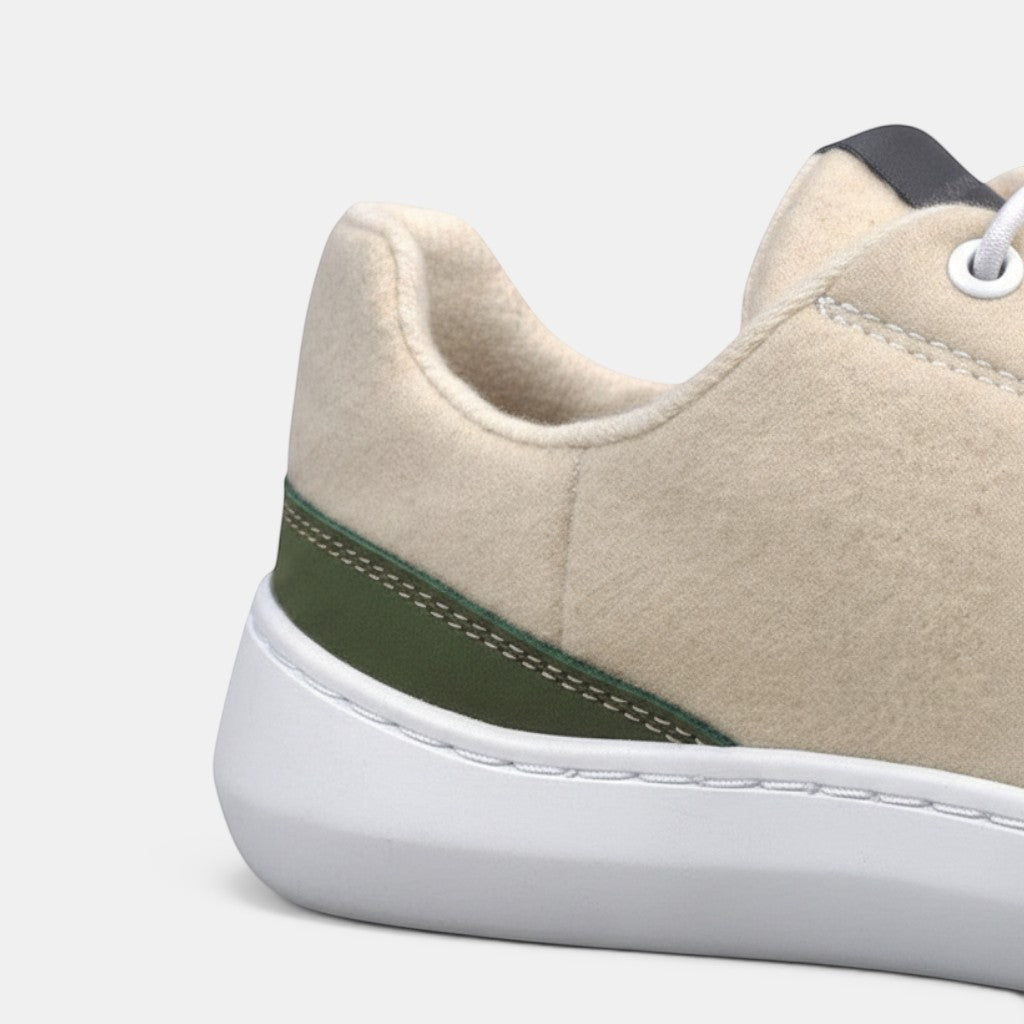Baabuk Zero Wooler Low natural wool sneakers with white sole and green accent.